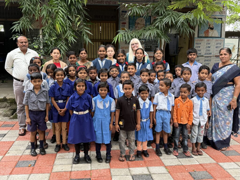 Children and adults gathered outside a school building